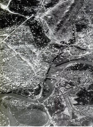 Panoramic view of the central area of Điện Biên with defensive strongpoints and air-dropped supply parachutes