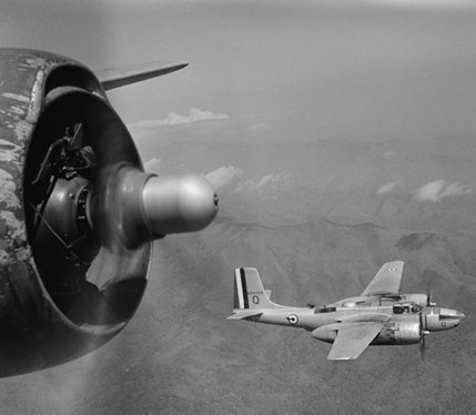 A Douglas B-26C Invader bomber in flight, bombing Điện Biên Phủ.