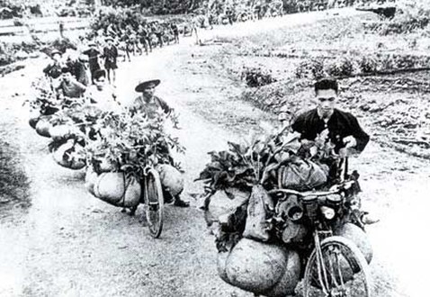 Viet Minh supply workers transport heavy loads using modified bicycles (xe đạp thồ).