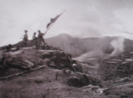 Vietnamese soldiers raising the victory flag over a captured French command bunker